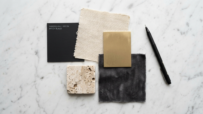 Mood board swatches for styling a black and gold room including matte black, brushed gold, and cream linen